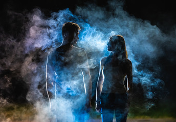 The silhouette of couple in the smoke