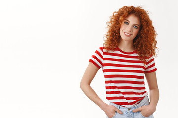 Confident assertive gorgeous curly-haired redhead woman hold hands pockets self-assured smiling...