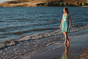 cute girl walking on the beach in summer