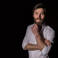 Portrait handsome bearded man, sexy guy on a dark background. free space for text
