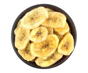 Banana chips in bowl on white background