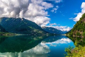 Naklejka na ściany i meble Amazing nature view with fjord and mountains. Beautiful reflection. Location: Scandinavian Mountains, Norway. Artistic picture. Beauty world. The feeling of complete freedom