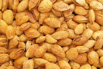 Almond nuts with nutshells background