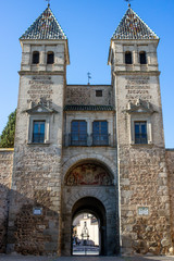external view of puerta bisagra with statue at toledo, spain - english translation : bisagra gate