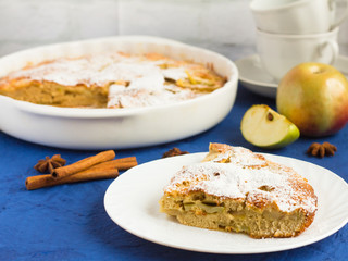 traditional homemade Apple pie with cinnamon and tea utensils on the table