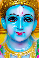 Closeup Portrait of  Hindu God Krishna in colorful high glossy statue.