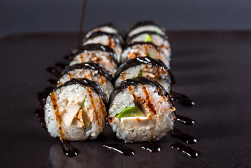 Japanese traditional roll with eel on black background