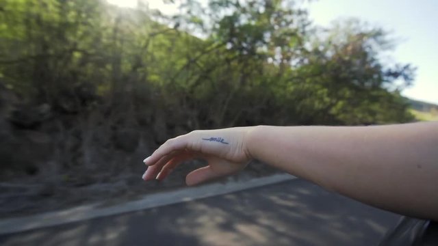 Slow Motion: Woman's Hand Out Side Of Car, Smile Tattoo, Kauai, Hawaii