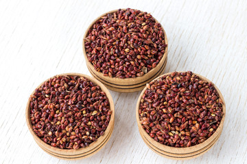 Three boxes with red millet on a white background