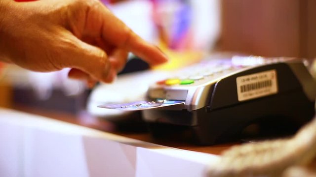Hand put credit card In slot of credit card reader and press the button, credit card payment, buy and sell products & service, the concept of payment without cash, selective focus.