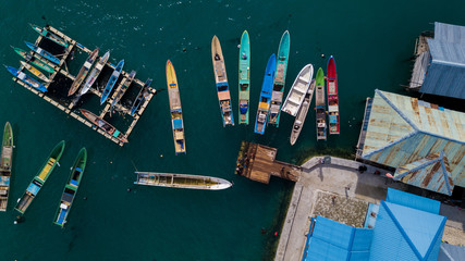 Fototapeta na wymiar Aerial view or bird view of jetty with many wooden boats are docking