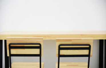 Wooden tables and chairs in a white room