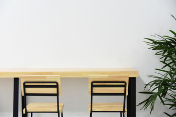 Wooden tables and chairs in a white room