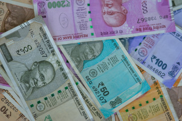 Closeup of brand new colorful Indian currency bank notes of 10, 50, 100, 200, 500 and 2000 rupees bundle issued and in circulation after demonetisation 