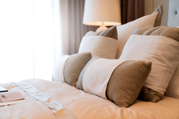 close up white beige soft pillows on bed and blanket bedroom interior design concept.bed maid luxury ideas concept