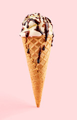 White ice cream ball in a Waffle Cone on a pink Background. Fruit ice cream in a waffle cone.