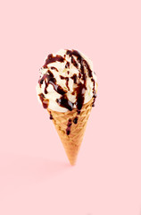 White ice cream ball in a Waffle Cone on a pink Background. Fruit ice cream in a waffle cone.