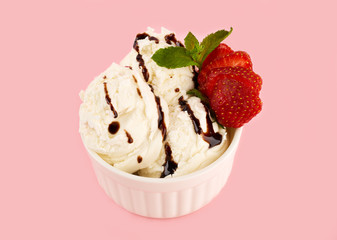 White ice cream ball in a Waffle Cone on a pink Background. Fruit ice cream in a waffle cone.
