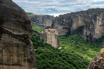 Secluded Greek monastery on top of rock cliff v9