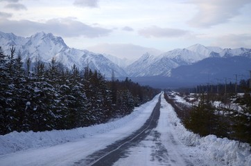 winter evening road to mountains