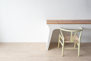Minimalist architect designer concept with green classic chair and modern table on wooden floor with white wall background.