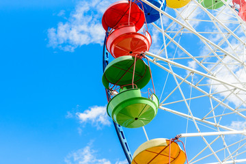 Ferris wheel against the blue sky, close-up