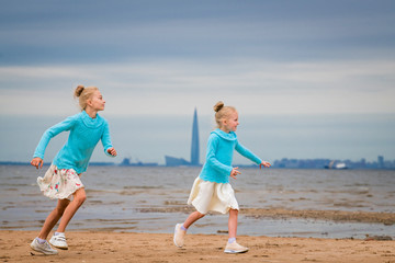 Fototapeta na wymiar girls running along the bay