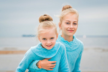 sisters in a blue sweater