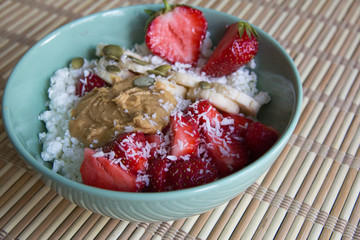 Cottage cheese with peanut butter, coconut, strawberries and bananas