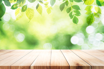 Empty table for present product with green bokeh background.