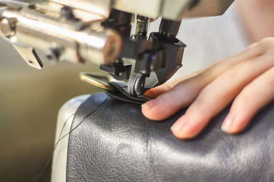 Sewing Machine In A Leather Workshop In Action With Hands Working With A Leather Details