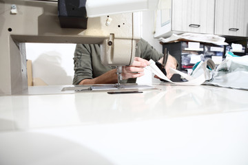 woman hands sewing machine, close up