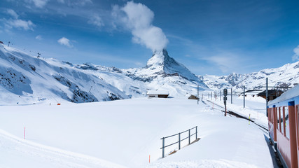 The famous mountain Matterhorn peak with cloudy and blue sky from Gornergrat, Zermatt, Switzerland
