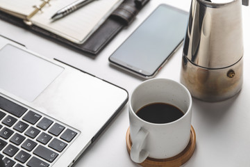 close up of smartphone, laptop, note and coffee cup . business and workplace concept . isolated...