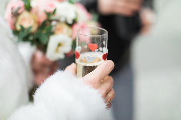 Glass of champagne in a hand of the bride. Glass of champagne in a hand of the bride, wedding background