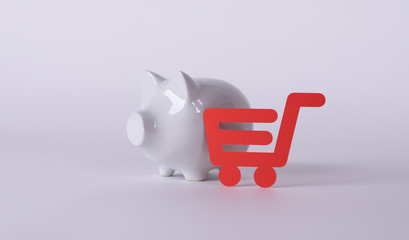 Shopping cart versus pig money box. Save money against spending money.