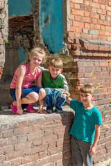 Three children in a destroyed house are hiding from military conflicts, refugee children have...