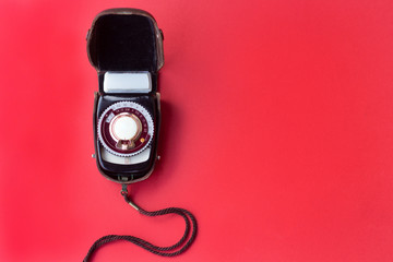 old vintage Soviet exposure meter with leather case on red background