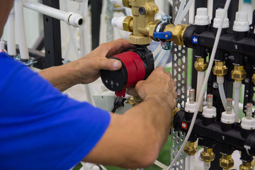 Technician mounting the heating system for the house. Industry