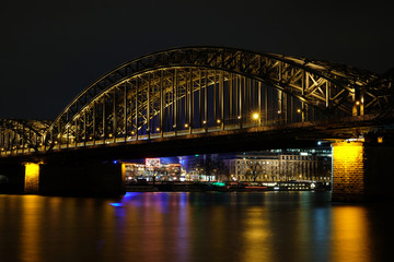 Naklejka na ściany i meble Cologne Cathedral and Hohenzollern Bridge at night in Cologne, Germany