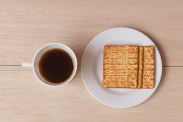 Obraz na płótnie Canvas Taza de café con galletas sobre mesa de madera