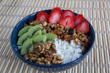 Cottage cheese with strawberries, kiwi, granola and nuts 