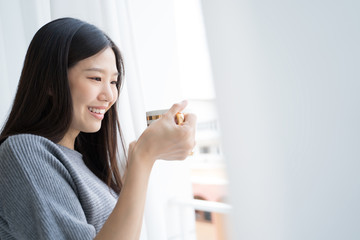 Portrait Asian woman relaxing with coffee at home