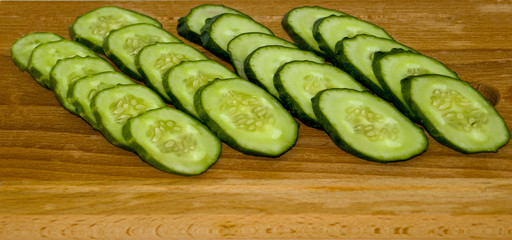 Cucumber cut into circles , slices on a wooden Board