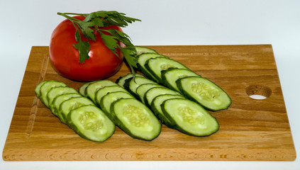 Cucumber, tomato,  dill, on cutting Board
