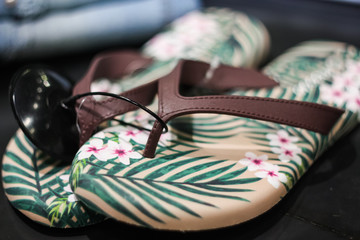 Brown flip-flops with pattern in a clothing boutique. Soft focus