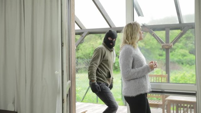 Shocking day time kidnapping as a masked man grabs a woman from her home