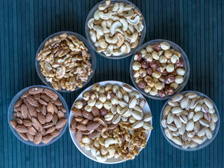 Healthy food. Nuts mix assortment on stone texture top view. Collection of different legumes for background image close up nuts, pistachios, almond, cashew nuts, peanut, walnut. image