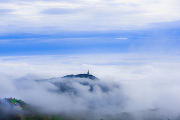 Naklejka na ściany i meble Temple at hilltop amidst fog, Phu tabberk ,Petchabun,Thailand...