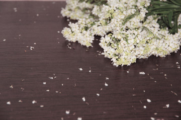 Flowers on a table sprinkled with petals